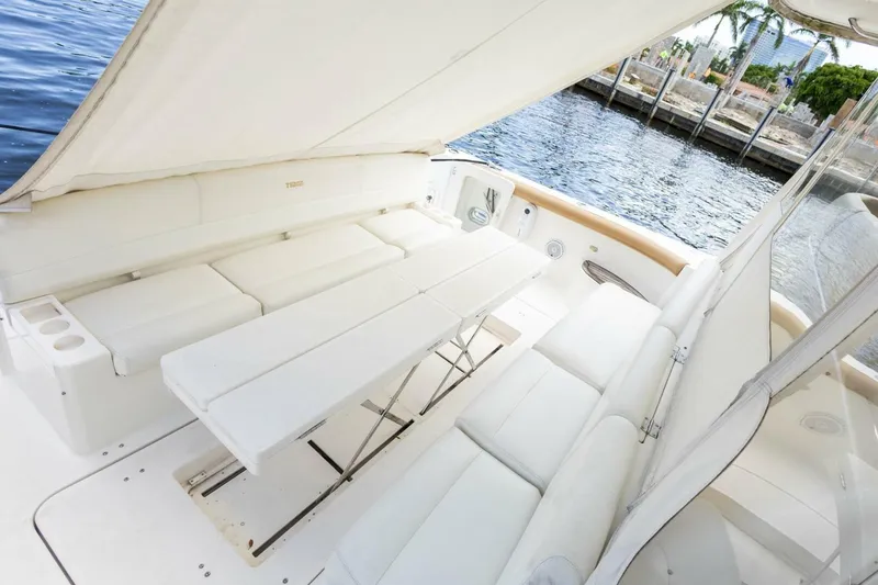Slide: The Image of Luxurious seating area on a 2000 Tiara Yachts 5200 Express by the water. - 4