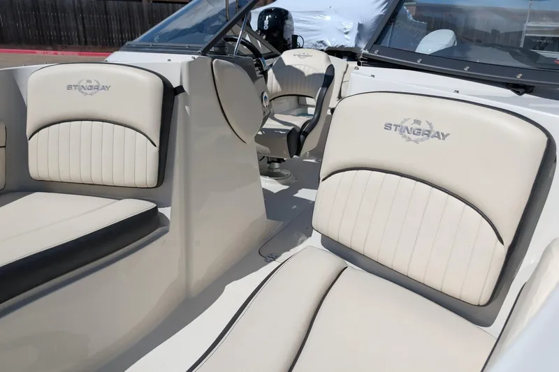 Slide: The Image of 2021 Stingray 204 LR boat interior with branded seating and steering wheel. - 10