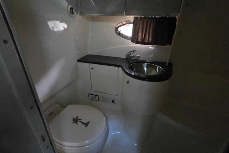 Slide: The Image of Interior of a 2004 Formula 370 Super Sport boat bathroom with sink and toilet. - 19