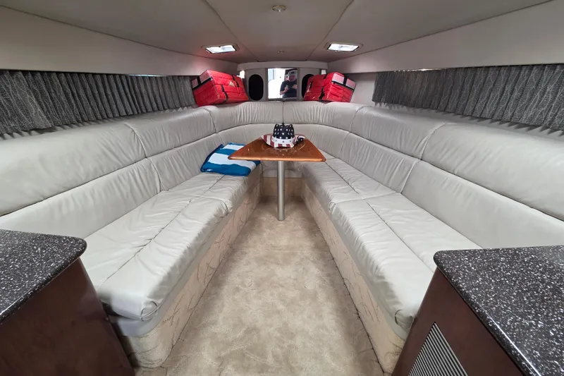Slide: The Image of Interior of 2004 Formula 370 Super Sport boat with plush seating and table. - 20