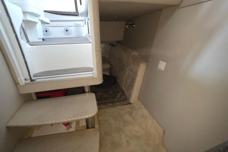 Slide: The Image of Interior cabin of 2004 Formula 370 Super Sport boat with stairs and seating area. - 21