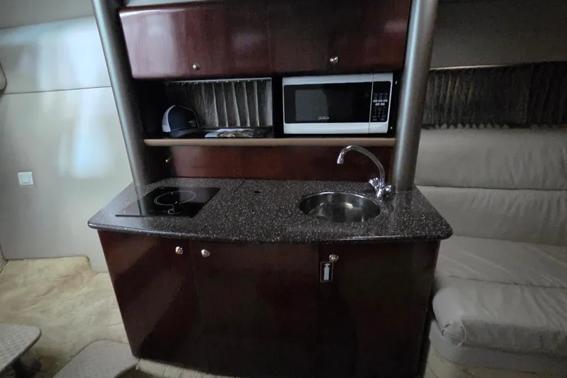 Slide: The Image of Interior of 2004 Formula 370 Super Sport yacht with kitchenette, sink, and microwave. - 18
