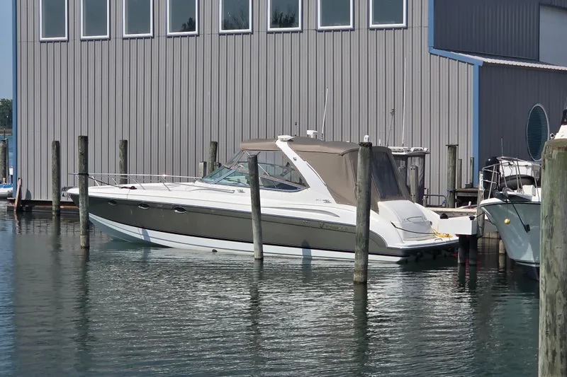 The Image of 2004 Formula 370 Super Sport boat docked near a marina building. - 1