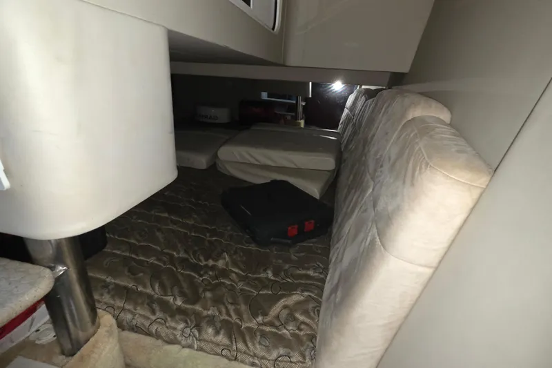 Slide: The Image of Interior cabin of a 2004 Formula 370 Super Sport boat with cushions and storage. - 22