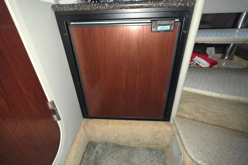 Slide: The Image of 2004 Formula 370 Super Sport interior with compact wooden cabinet and carpeted steps. - 24