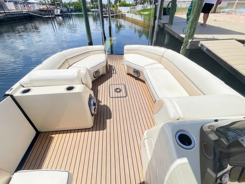 Slide: The Image of The image shows the deck of a 2015 Harris FloteBote Crown DL 250 with beige seating and wood flooring. - 38
