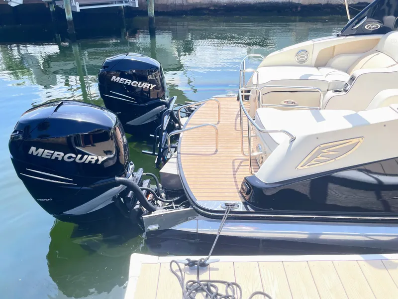 Slide: The Image of A 2015 Harris FloteBote Crown DL 250 with two Mercury outboard engines, docked at a pier. - 18