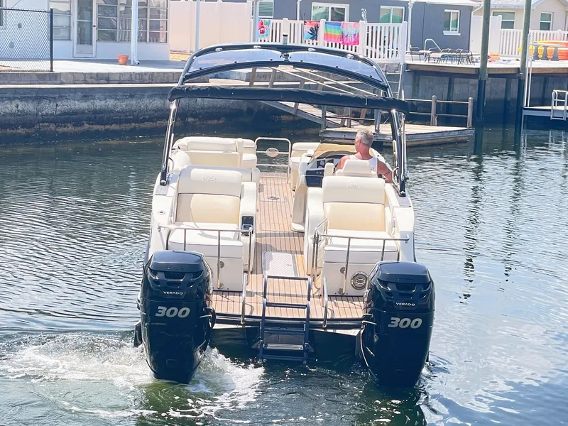 Slide: The Image of A 2015 Harris FloteBote Crown DL 250 on the water, featuring two 300 HP engines. - 8