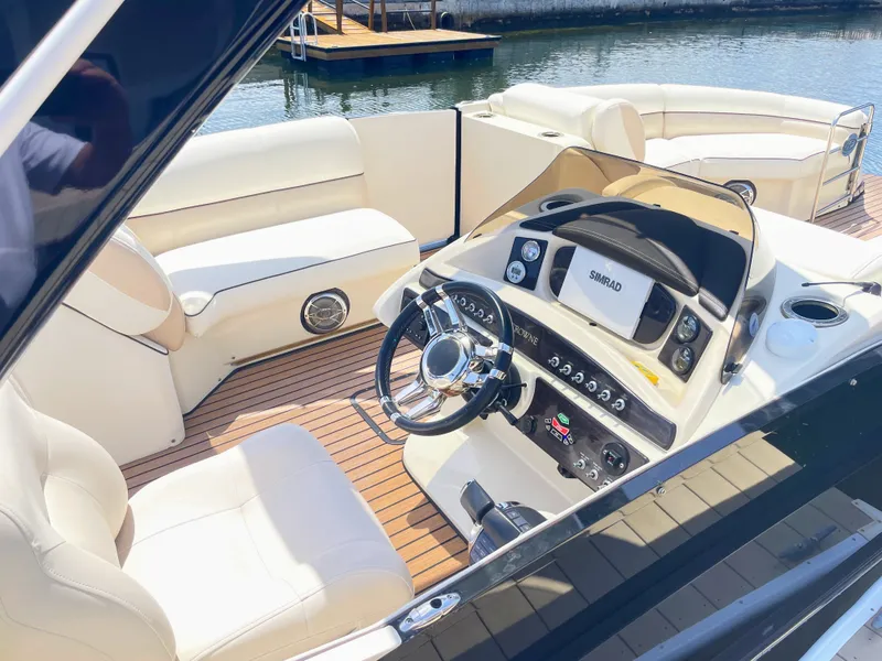 Slide: The Image of The image shows the cockpit of a 2015 Harris FloteBote Crown DL 250 with sleek seating and a modern helm. - 20