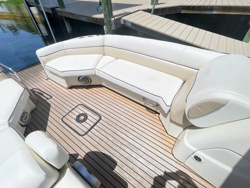 Slide: The Image of The image shows the deck of a 2015 Harris FloteBote Crown DL 250 with white upholstery. - 41
