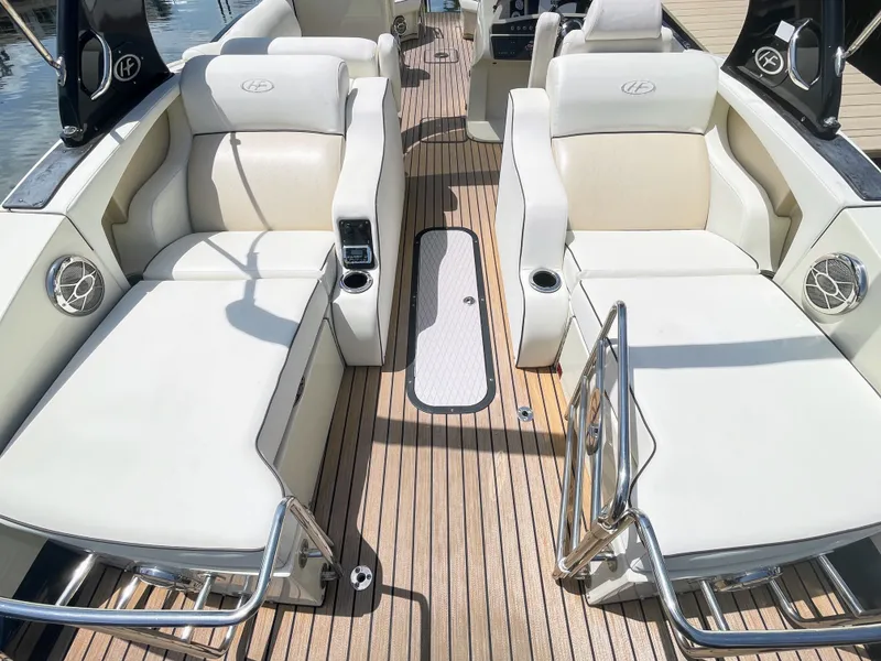 Slide: The Image of The image shows the luxurious interior of a 2015 Harris FloteBote Crown DL 250 with comfortable seating and wood flooring. - 24