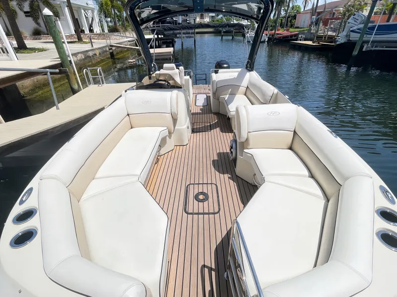 Slide: The Image of 2015 Harris FloteBote Crown DL 250 with sleek white seating and wood flooring, docked by the water. - 44