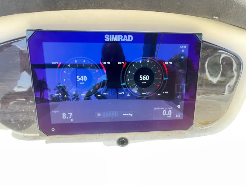 Slide: The Image of A Simrad display shows boat information like speed and depth, surrounded by a plastic casing. - 33