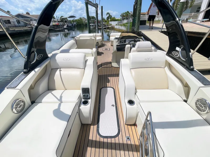 Slide: The Image of The image shows the interior of a 2015 Harris FloteBote Crown DL 250 with sleek white seating. - 25