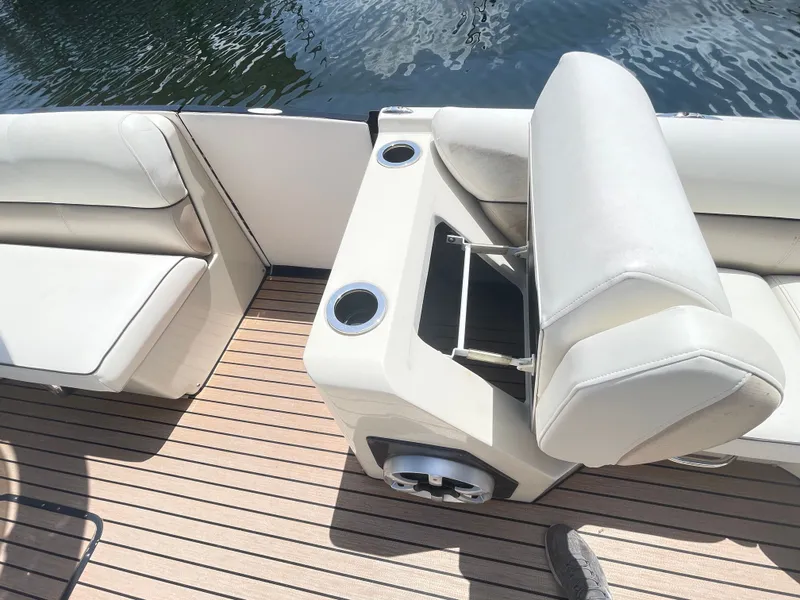 Slide: The Image of 2015 Harris FloteBote Crown DL 250 with sleek seating and cup holders on a wooden deck. - 49