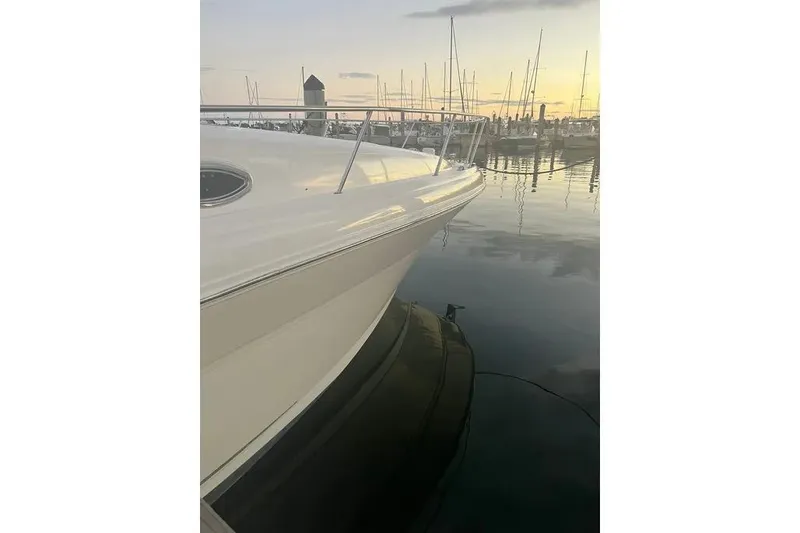 Slide: The Image of 2006 Sea Ray 340 Sundancer docked at sunset, reflecting on calm water. - 3