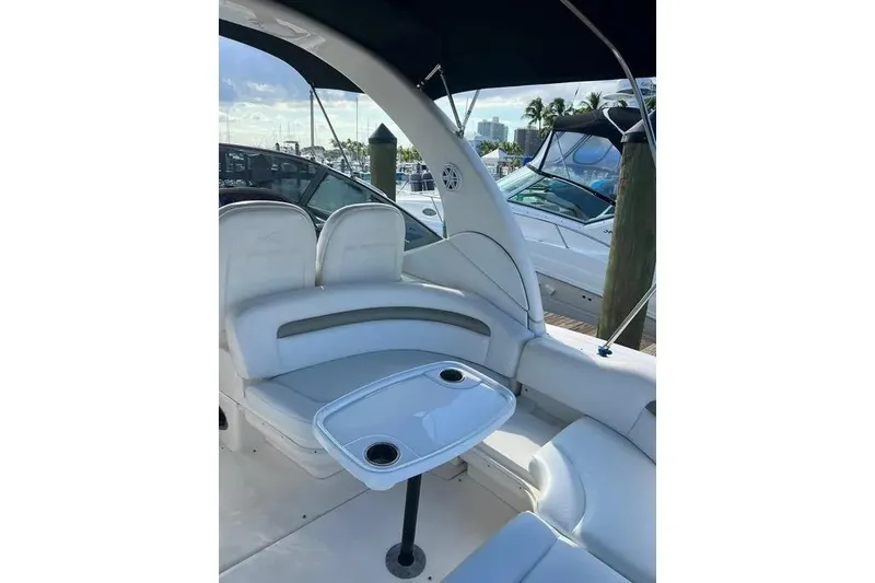 Slide: The Image of 2006 Sea Ray 340 Sundancer boat interior with seating and table, docked at marina. - 10