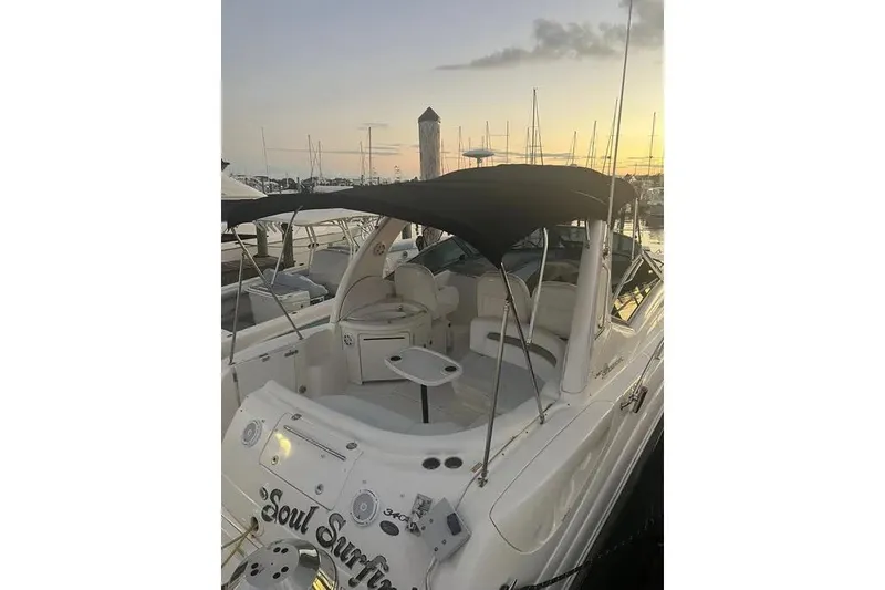 Slide: The Image of 2006 Sea Ray 340 Sundancer yacht docked at sunset, featuring a sleek design and spacious deck. - 11