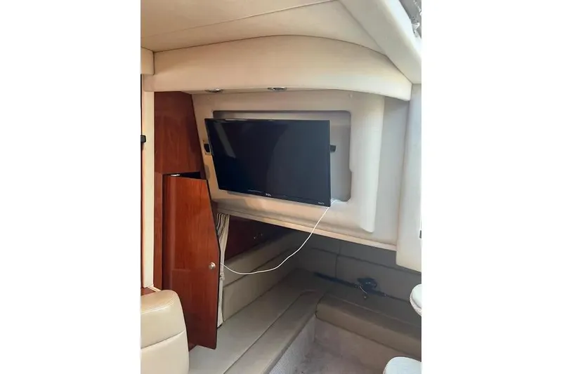 Slide: The Image of Interior of 2006 Sea Ray 340 Sundancer with TV and wooden cabinetry. - 9