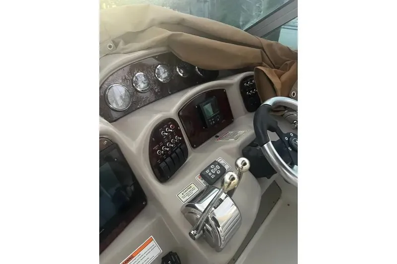 Slide: The Image of 2006 Sea Ray 340 Sundancer helm with gauges, controls, and steering wheel. - 8