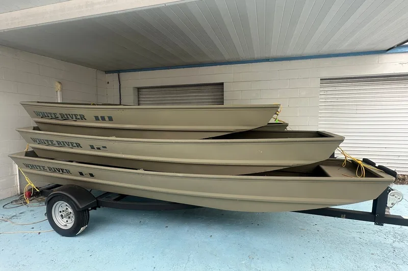 Slide: The Image of Stacked 2025 White River Topper 1236 boats on trailer in covered area. - 10