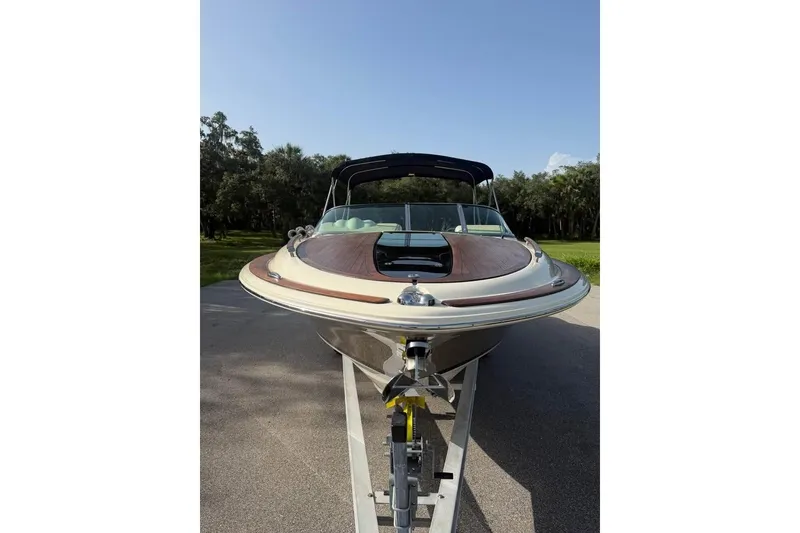 Slide: The Image of 2018 Chris-Craft Corsair 30 boat on trailer, showcasing sleek design and luxury features. - 7