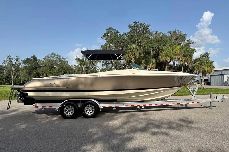 The Image of 2018 Chris-Craft Corsair 30 boat on trailer, parked outdoors under clear sky. - 0