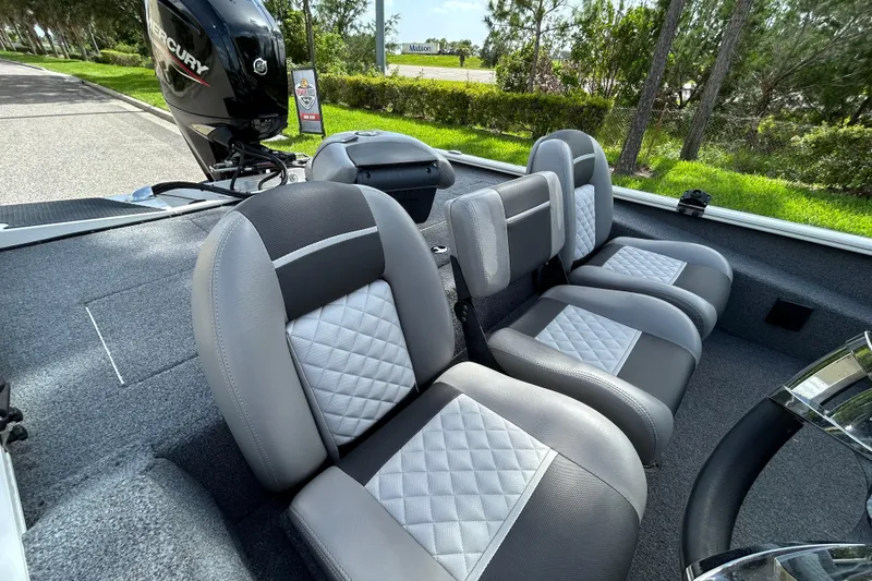 Slide: The Image of 2020 Triton 18 TX boat interior with gray and white quilted seats. - 10