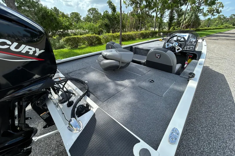 Slide: The Image of 2020 Triton 18 TX boat with Mercury engine, featuring spacious deck and modern controls. - 8
