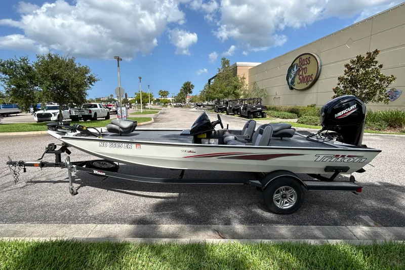 Slide: The Image of 2020 Triton 18 TX boat with Mercury engine parked outside Bass Pro Shops. - 4