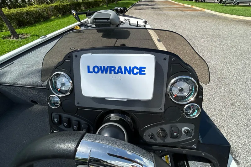 Slide: The Image of Dashboard of a 2020 Triton 18 TX boat featuring Lowrance Hook display. - 12