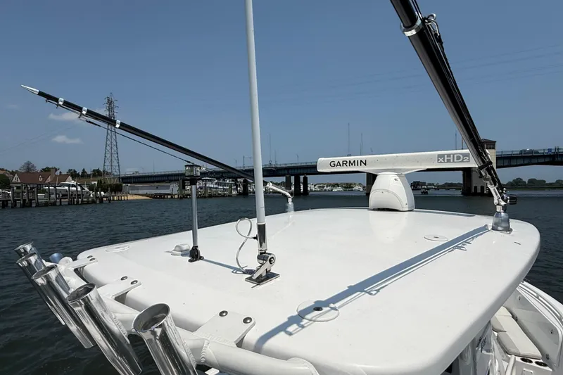 Slide: The Image of 2015 Everglades 295 Center Console boat with Garmin xHD2 radar, near a bridge. - 28