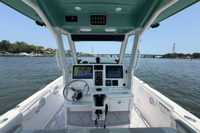 Slide: The Image of 2015 Everglades 295 Center Console boat interior with navigation system on open water. - 16