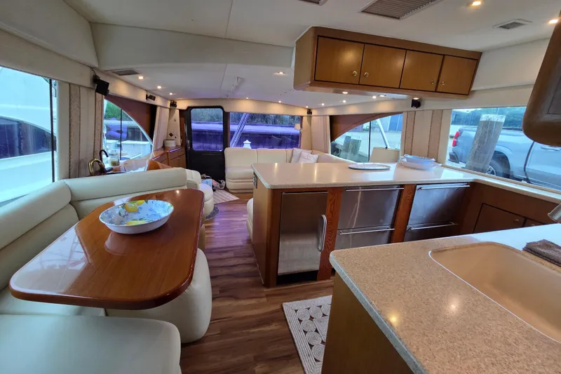 Slide: The Image of Luxurious interior of a 2002 Ocean 56 Super Sport yacht with modern kitchen and seating area. - 8