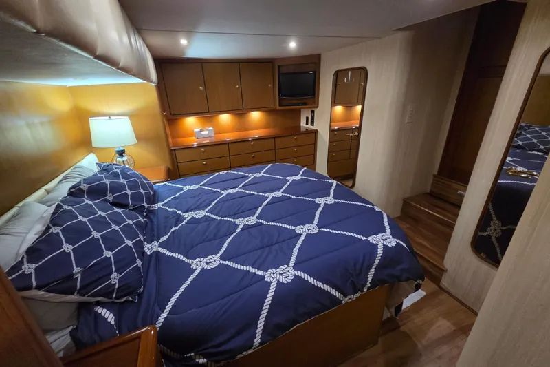 Slide: The Image of Luxurious cabin interior of 2002 Ocean 56 Super Sport yacht with cozy bedding and elegant wood finishes. - 13