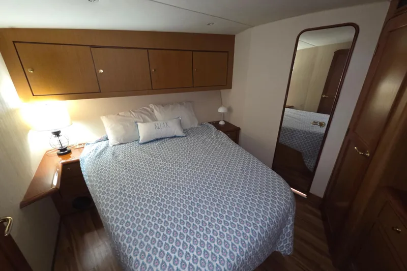 Slide: The Image of Cozy bedroom in 2002 Ocean 56 Super Sport yacht with elegant wood cabinetry. - 21