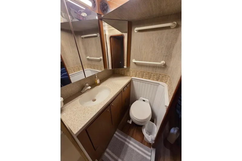 Slide: The Image of Bathroom interior of 2002 Ocean 56 Super Sport yacht, featuring sink and toilet. - 15