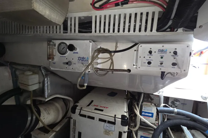 Slide: The Image of Engine room of 2002 Ocean 56 Super Sport yacht with control panels and equipment. - 39