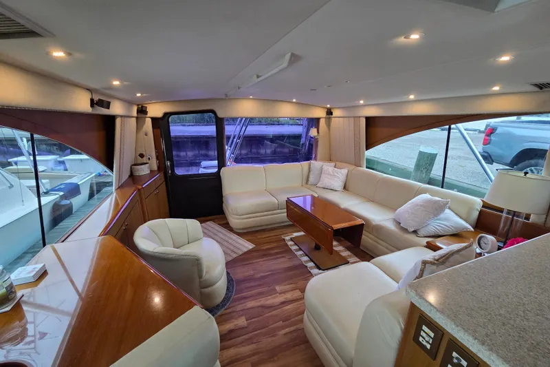 Slide: The Image of Luxurious interior of a 2002 Ocean 56 Super Sport yacht with plush seating and elegant design. - 4