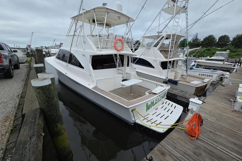 Slide: The Image of 2002 Ocean 56 Super Sport yacht docked at marina, overcast sky. - 43