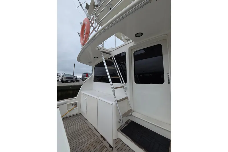 Slide: The Image of 2002 Ocean 56 Super Sport yacht with ladder and deck view. - 31