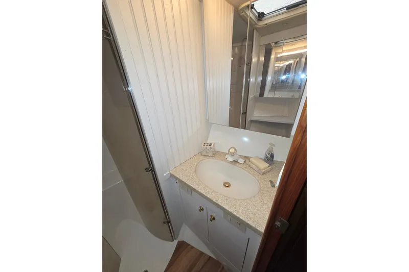 Slide: The Image of Bathroom interior of 2002 Ocean 56 Super Sport yacht with sink and mirror. - 24