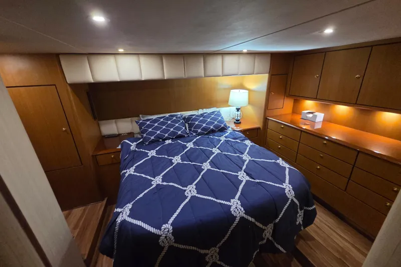 Slide: The Image of Luxurious bedroom interior of 2002 Ocean 56 Super Sport yacht with elegant wood cabinetry. - 12