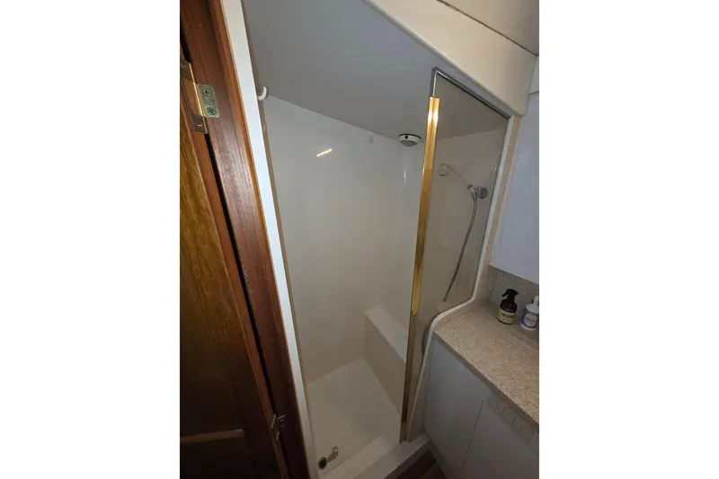 Slide: The Image of Shower area in 2002 Ocean 56 Super Sport yacht with glass door and countertop. - 20