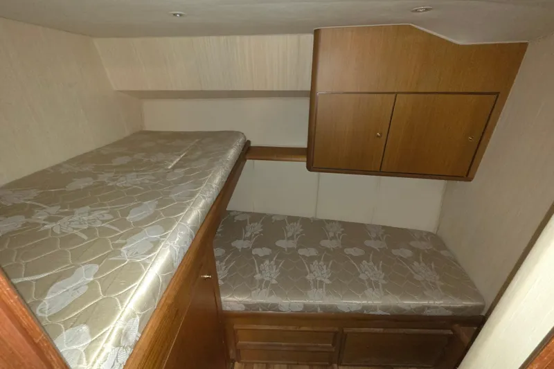 Slide: The Image of Interior cabin of 2002 Ocean 56 Super Sport yacht with bunk beds and wooden cabinets. - 17