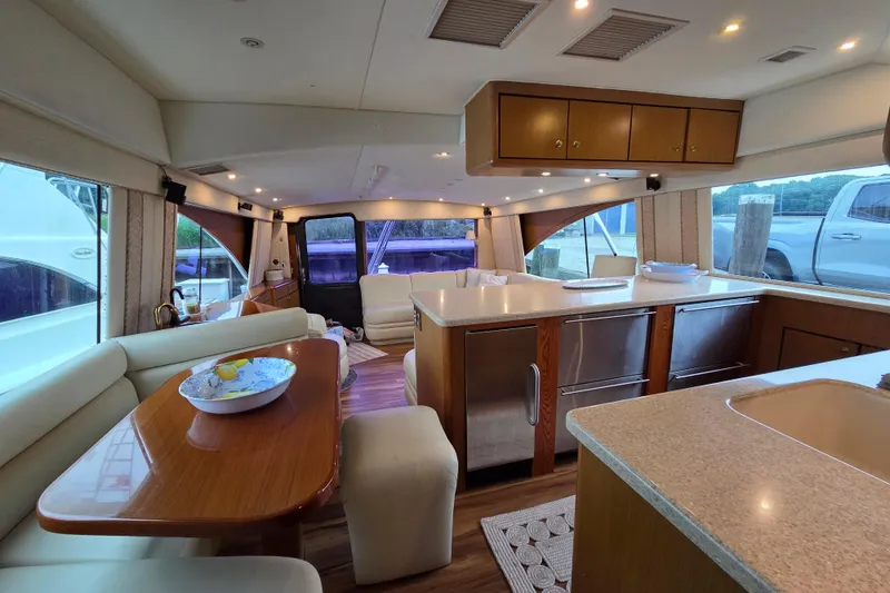 Slide: The Image of Luxurious interior of a 2002 Ocean 56 Super Sport yacht with modern kitchen and seating area. - 9
