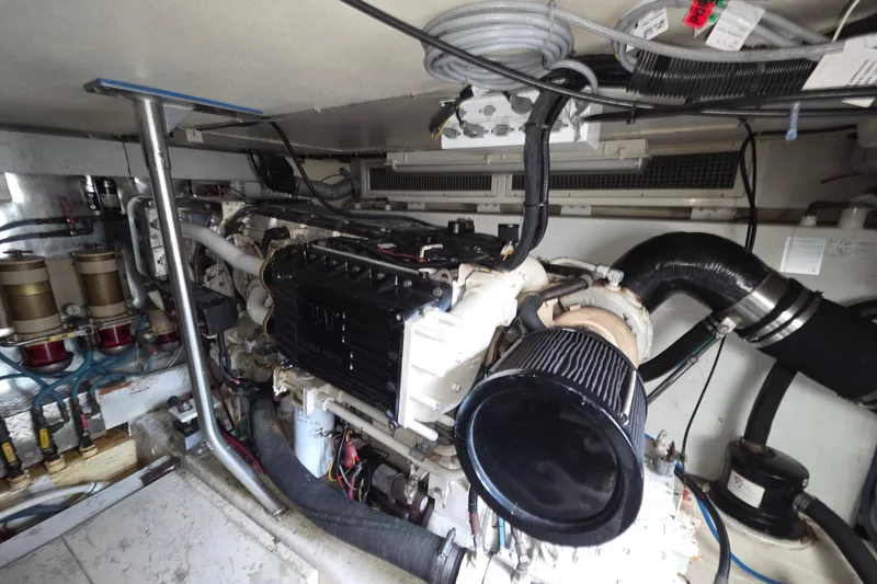 Slide: The Image of Engine room of a 2002 Ocean 56 Super Sport yacht, showcasing detailed machinery and components. - 36