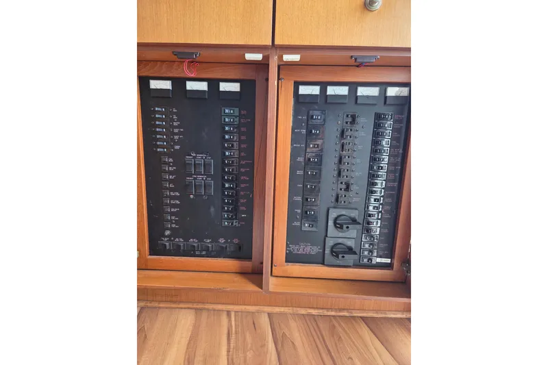 Slide: The Image of Electrical panel on a 2002 Ocean 56 Super Sport yacht, featuring circuit breakers and switches. - 26