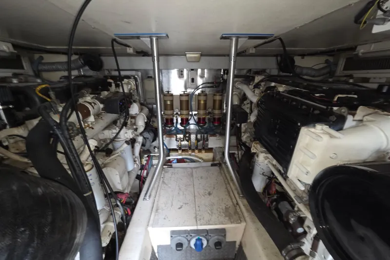 Slide: The Image of Engine room of a 2002 Ocean 56 Super Sport yacht, showcasing dual engines and mechanical components. - 34