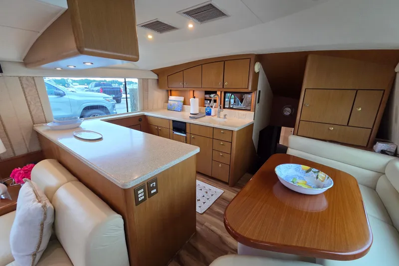 Slide: The Image of Luxurious interior of a 2002 Ocean 56 Super Sport yacht with modern kitchen and seating area. - 5